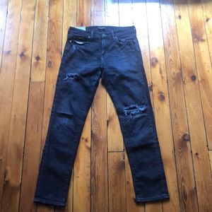Faded black distressed athletic skinny jeans